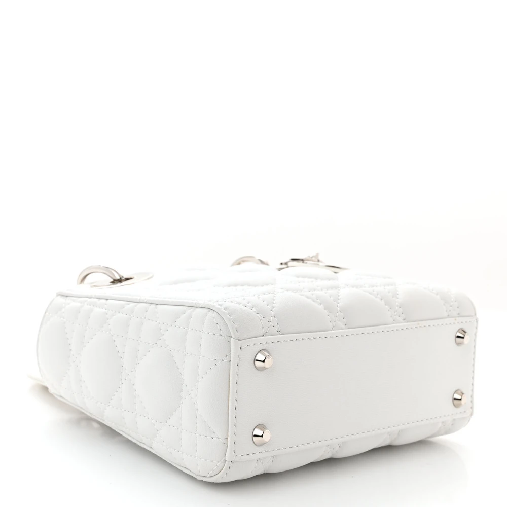 Bottom view of the white D!0r Mini Lady Dior Bag with Cannage stitching and silver-tone D.I.O.R. charms