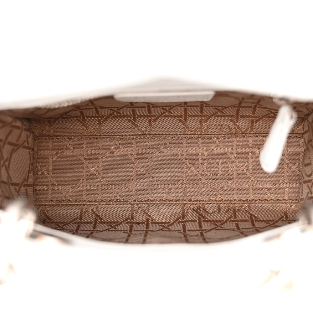 Interior view of the white D!0r Mini Lady Bag with suede lining and zip pocket