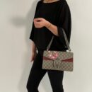 Model wearing the Mirror quality beige Gucc! Dionysus Blooms Small Shoulder Bag with pink floral print