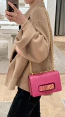 Model wearing the fuchsia D!0r J’Adior Chain Flap Bag crossbody