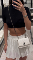 Model wearing the white Ch@nel Trendy CC WOC bag with chain strap
