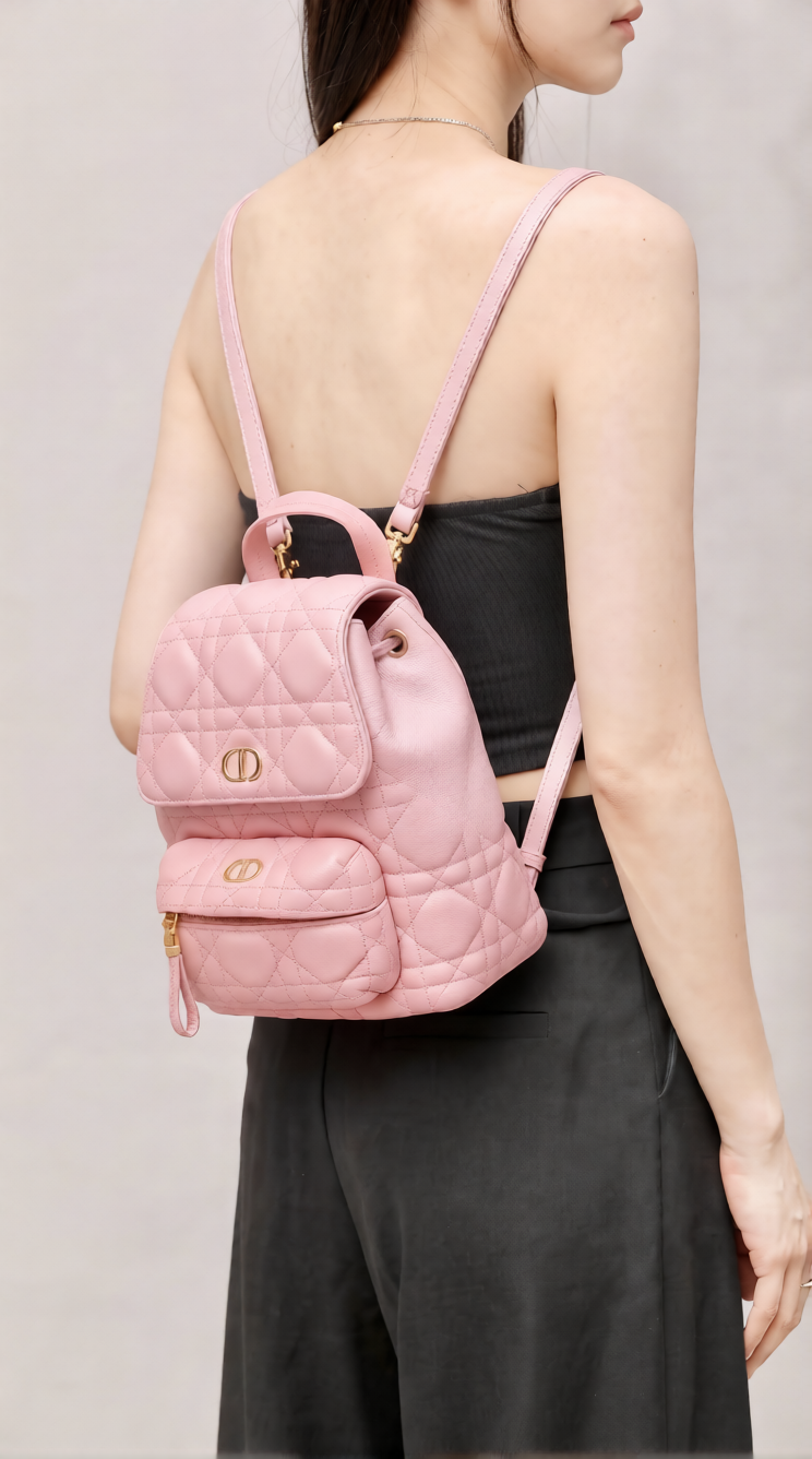 Model wearing the superfake blossom pink D!0r Mini Backpack with adjustable shoulder straps