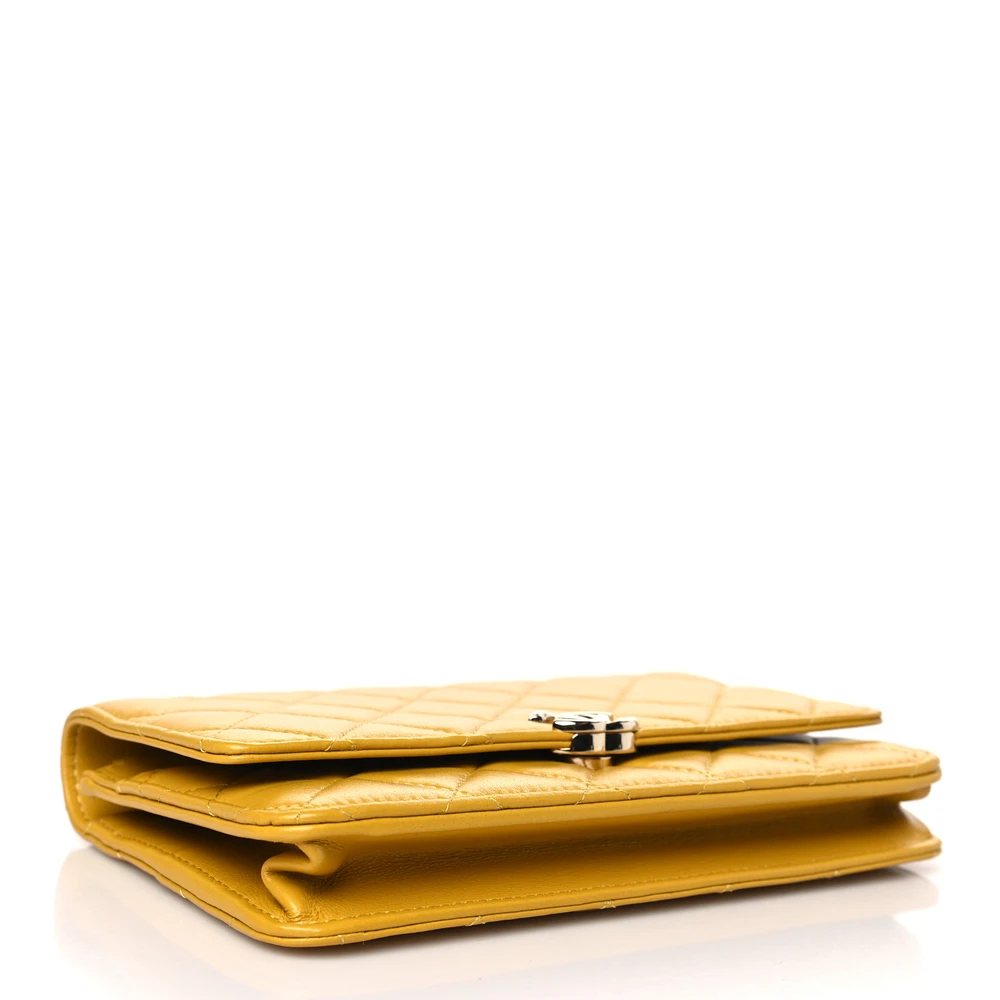 Bottom view of the yellow Ch@nel Wallet on Chain bag with CC detail and top handle