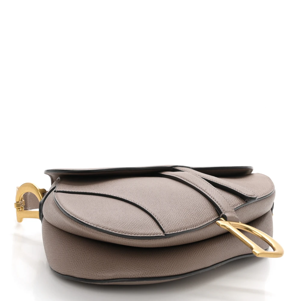 Bottom view of the warm taupe Replica Dior Medium Saddle bag with curved silhouette