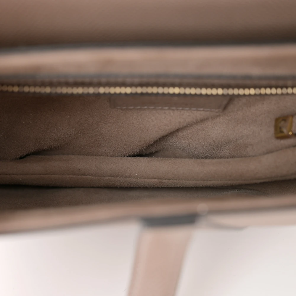 Warm taupe suede interior of the Saddle bag with zipper pocket
