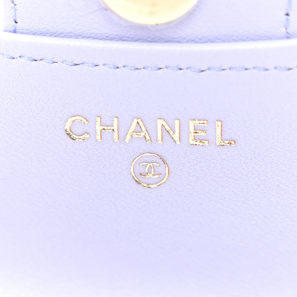 Close-up of the gold-tone CC closure on the light purple coin purse bag