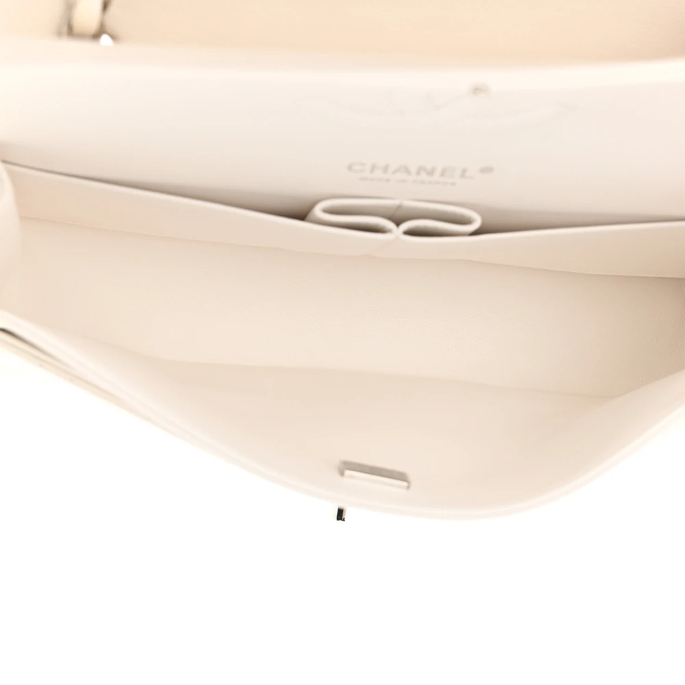 White leather interior of the Ch@nel Medium Double Flap bag with patch pockets