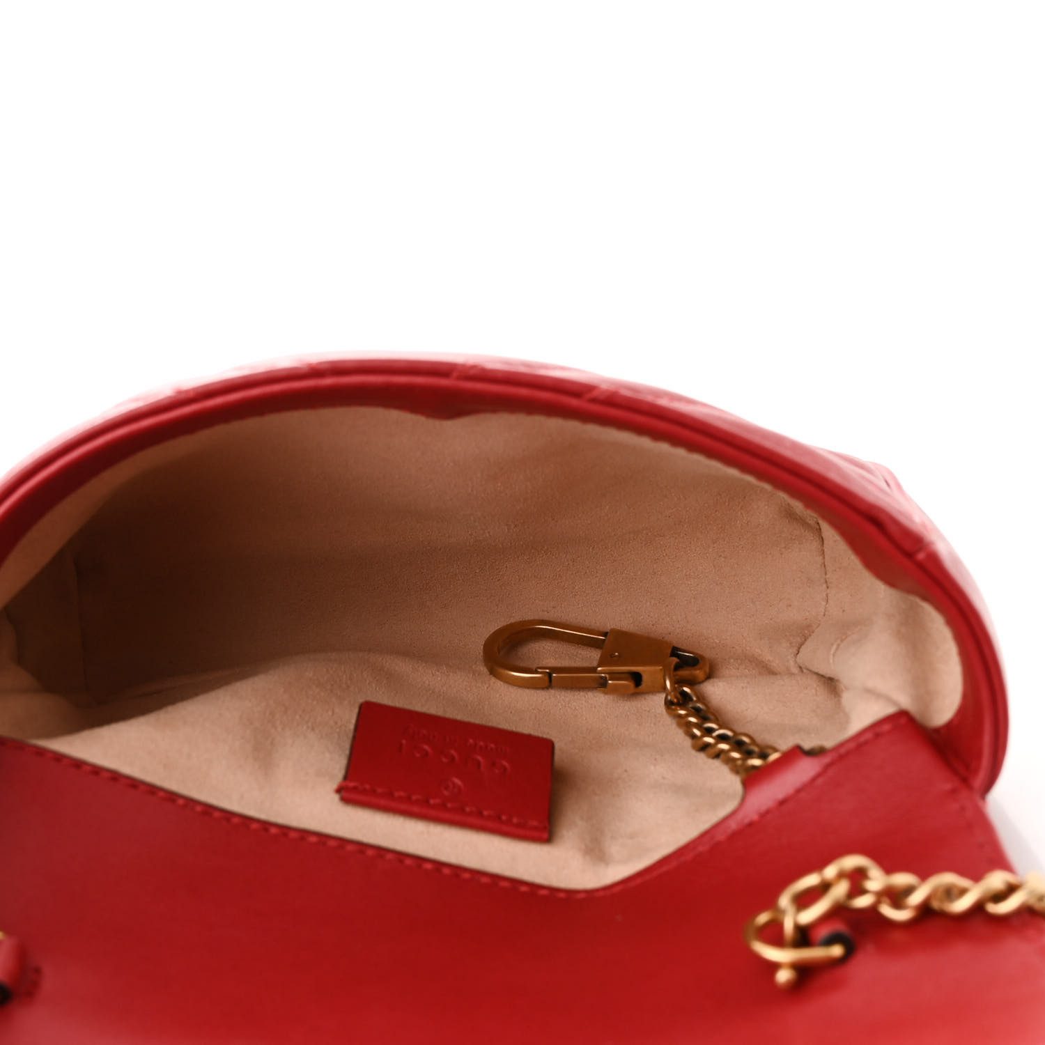 Interior of the red Gucc! Super Mini GG Marmont Bag with beige microfiber lining and key ring
