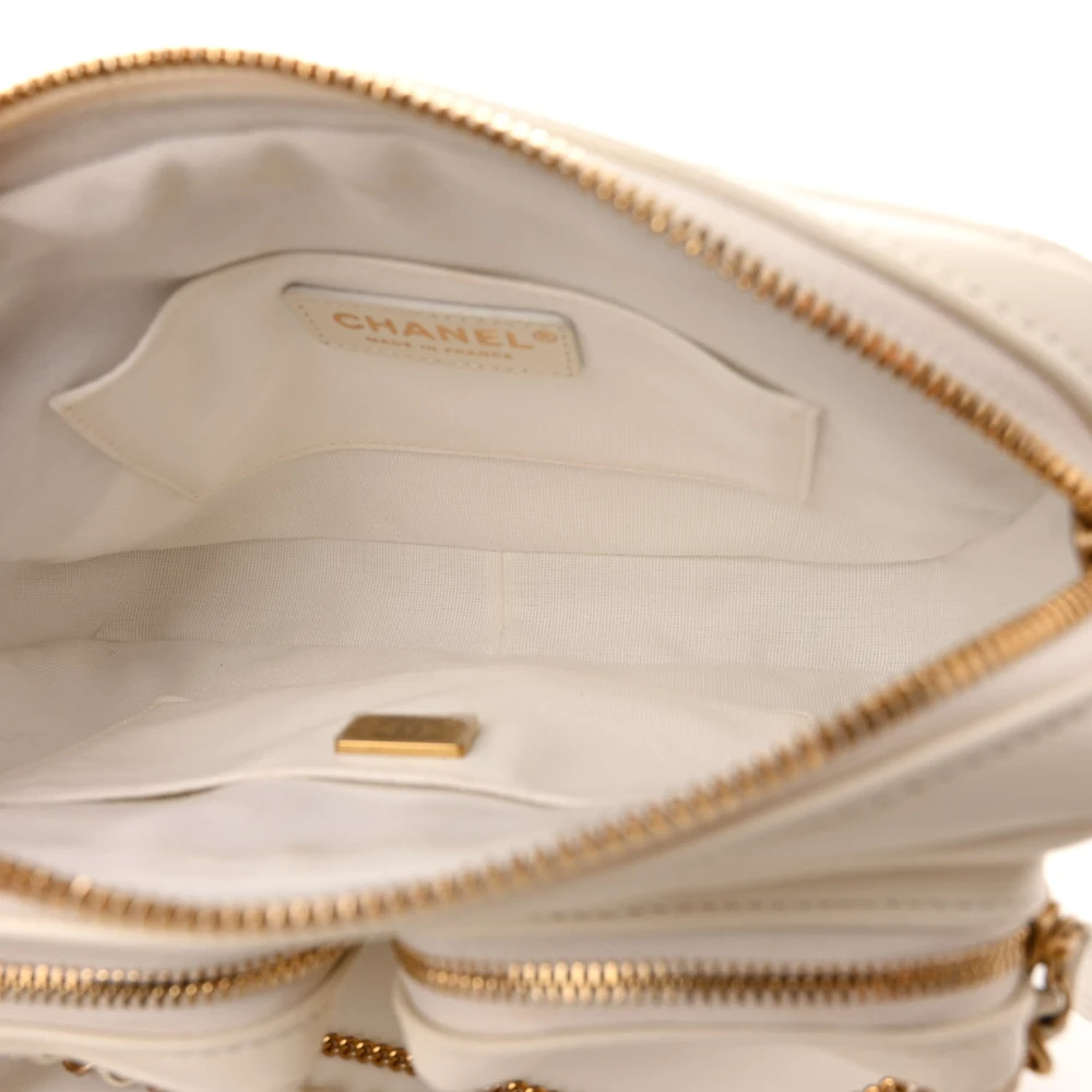 Fabric lined interior of the white Camera Case bag with zipper pocket