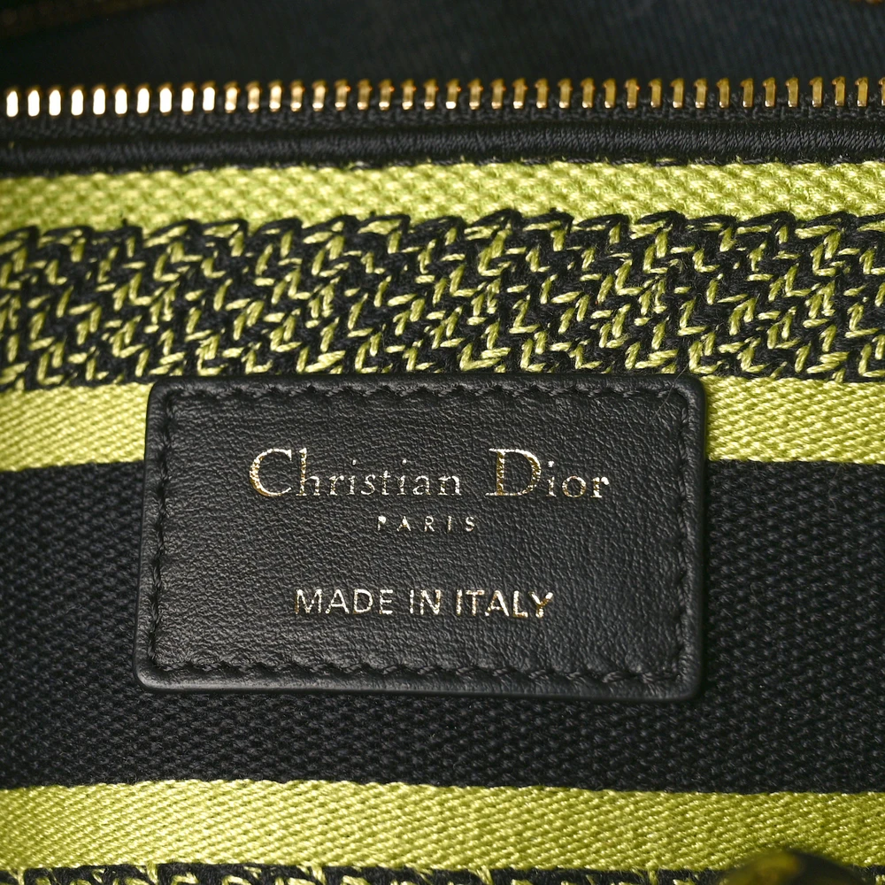 Close-up of the D!0r PARIS signature and pale gold-finish D.I.O.R. charms on the lime Lady D-Lite Bag
