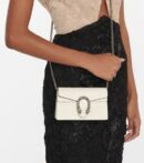 Model wearing the SuperFake Mystic White Gucc! Dionysus Small Shoulder Bag with silver-tone chain strap