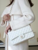 Model carrying the white quilted ch@nel Medium Double Flap shoulder bag