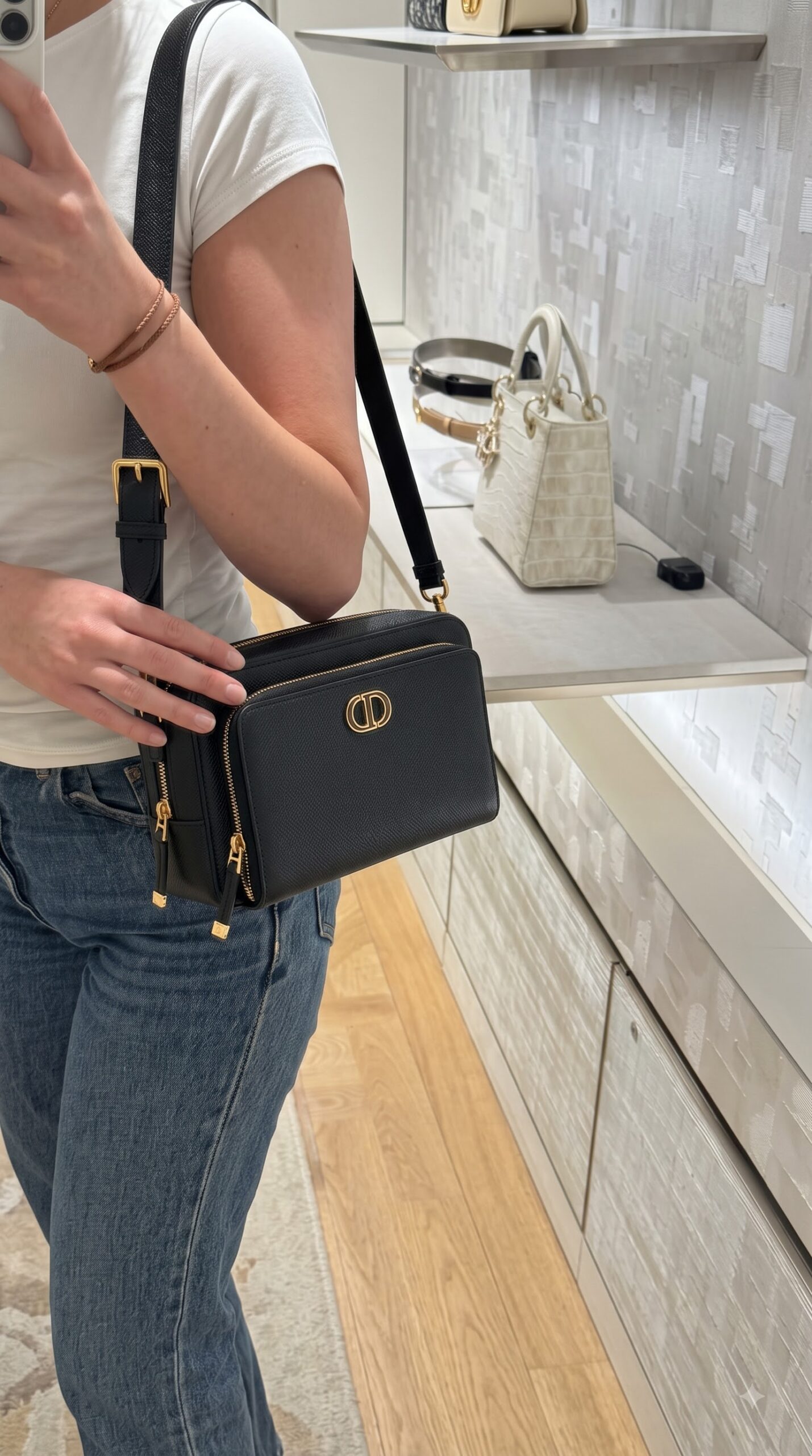 Model carrying the black D!0r Caro Double Pouch with matching shoulder strap