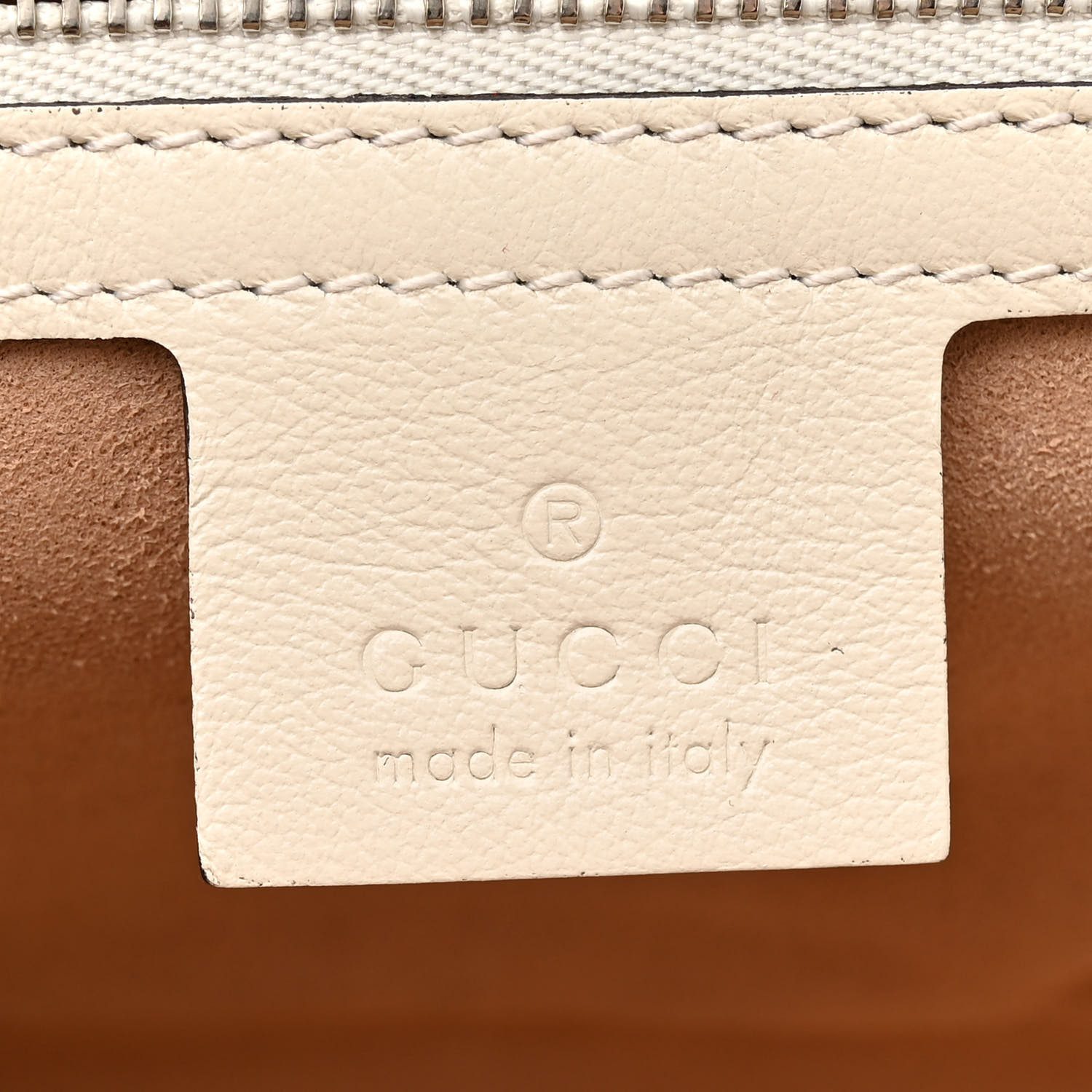 Close-up of the textured silver-tone GG logo and concealed press-lock closure on the blue Gucc! GG Marmont Bag