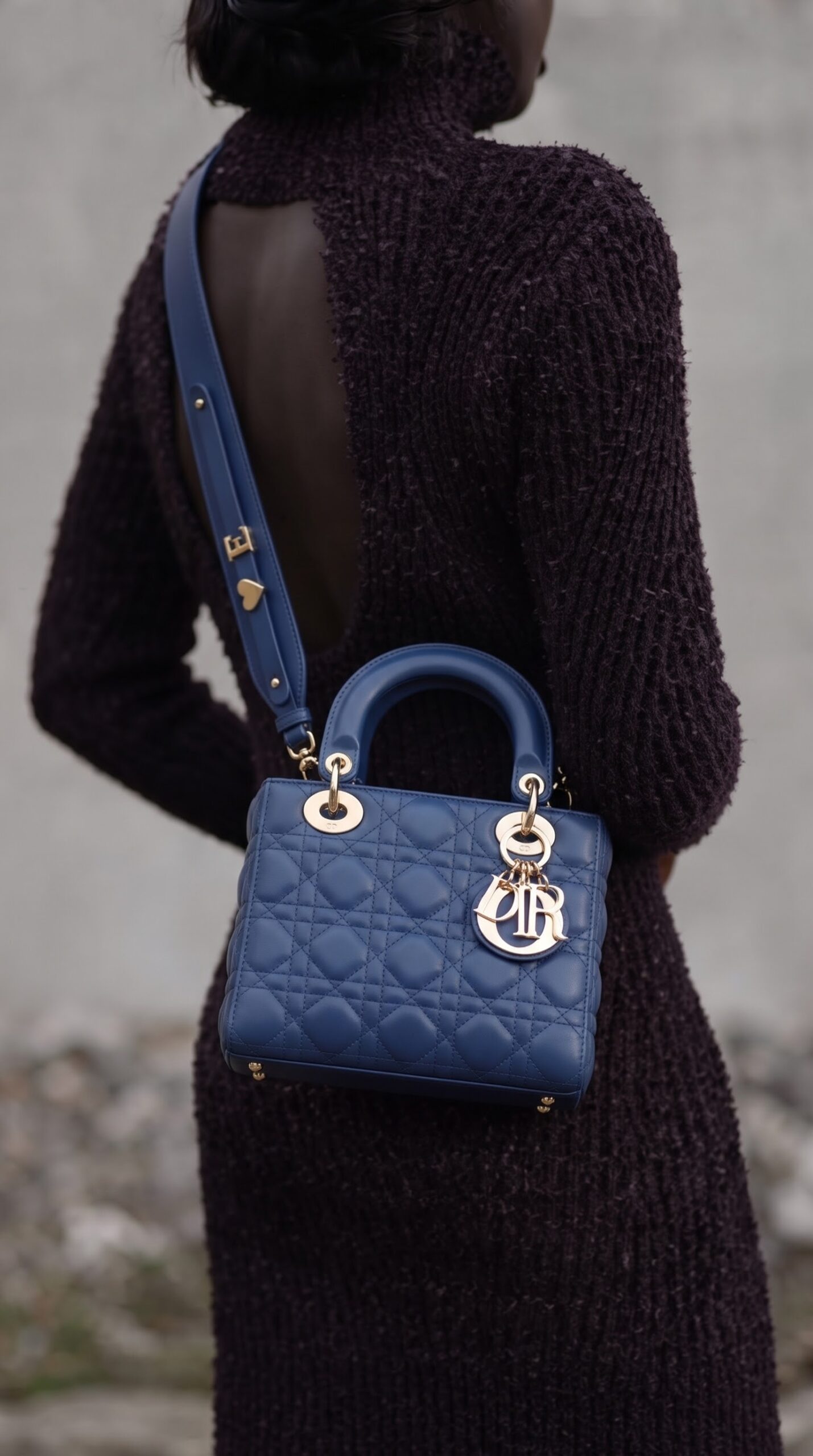 Model carrying the SuperFake blue Royale D!0r small Lady Bag with removable shoulder strap